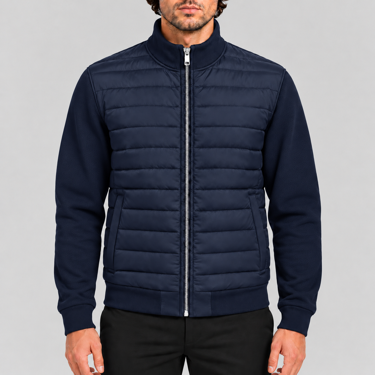 Men's hybrid quilted jacket with knitted sleeves in navy, zipped up, front view