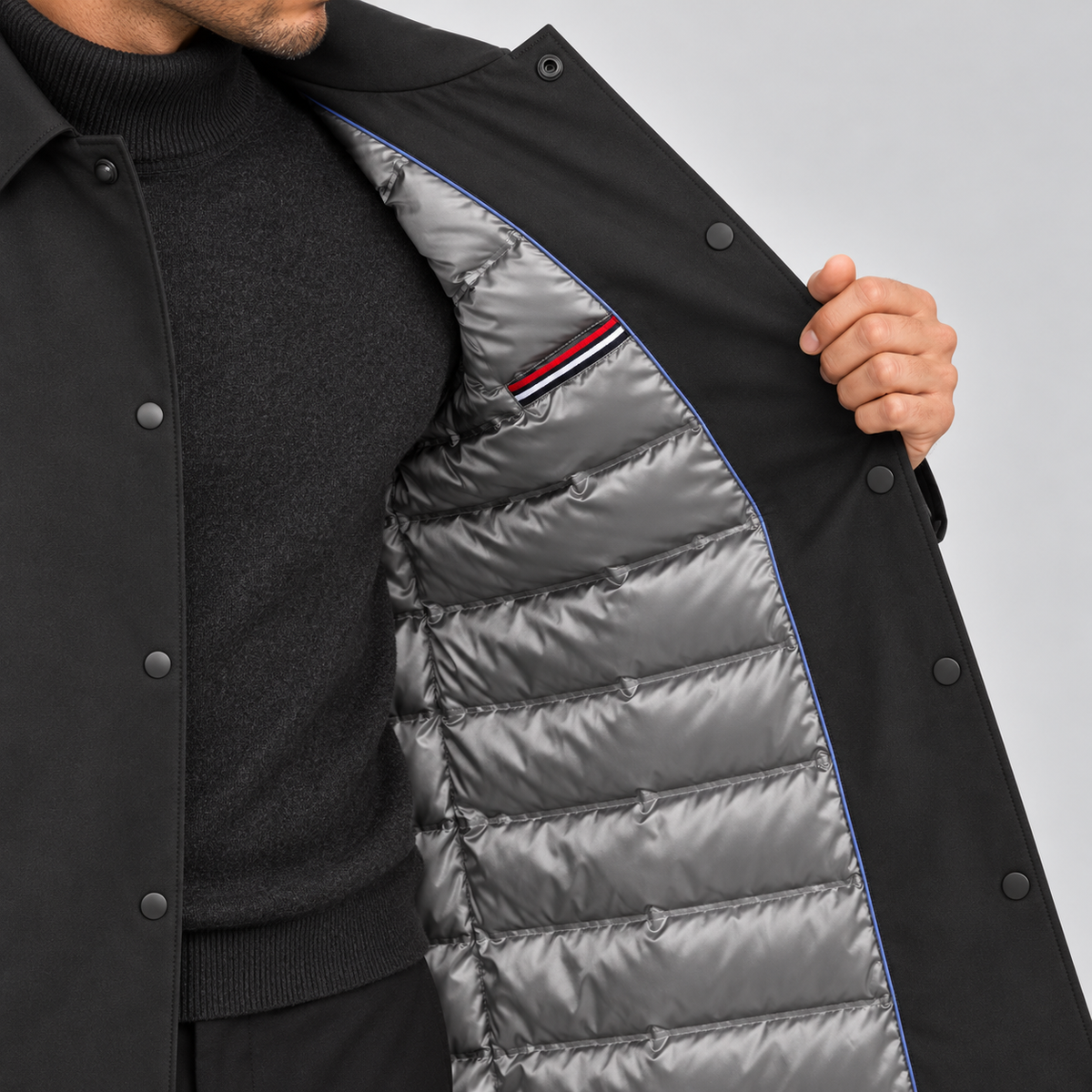 Grey quilted padded lining inside men's black mac coat